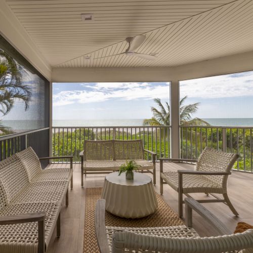 Outdoor patio with chairs and ocean view