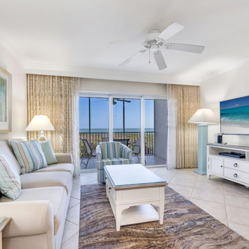 Bright and cozy living room with ocean views and beachy decor
