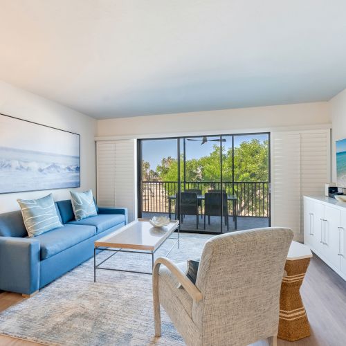 Simple and sunny living room with a beachy vibe and balcony view