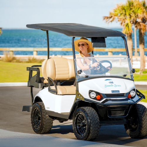 Guest driving a golf cart at South Seas
