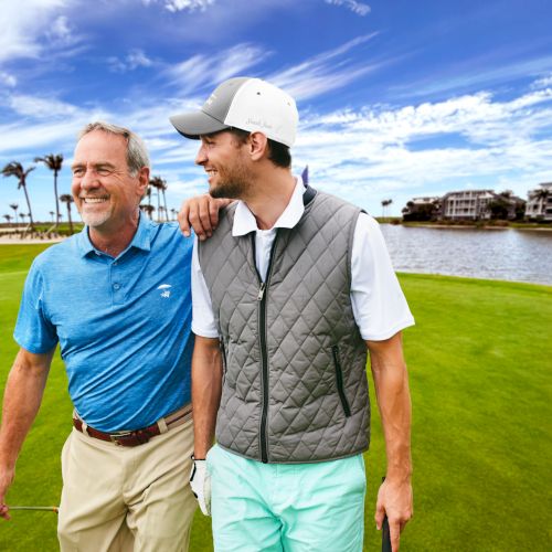Two golfers smiling on the course
