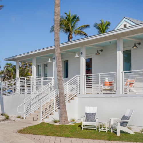 Coastal style ice cream shop with white exterior and palm trees