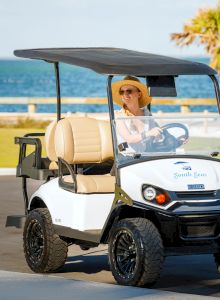 Guest driving a golf cart at South Seas