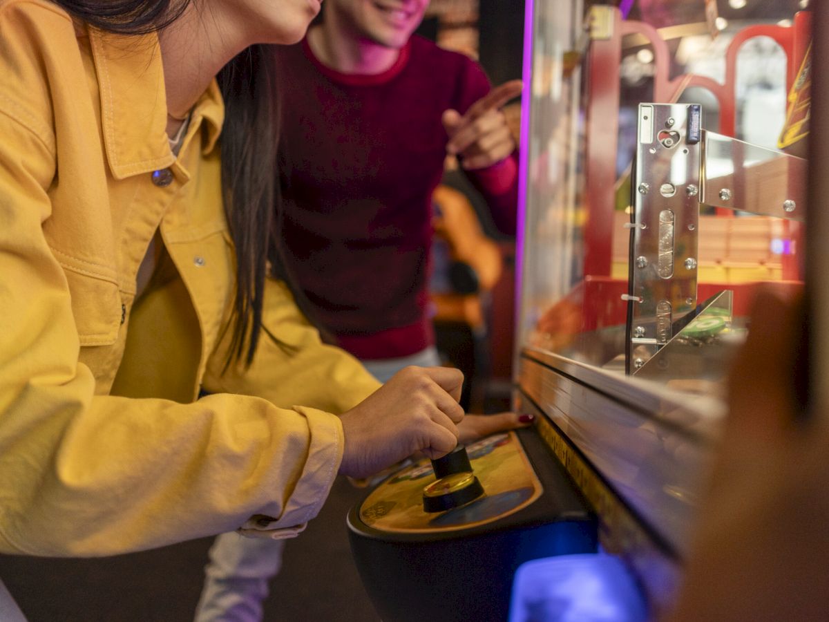Close up of people playing arcade games