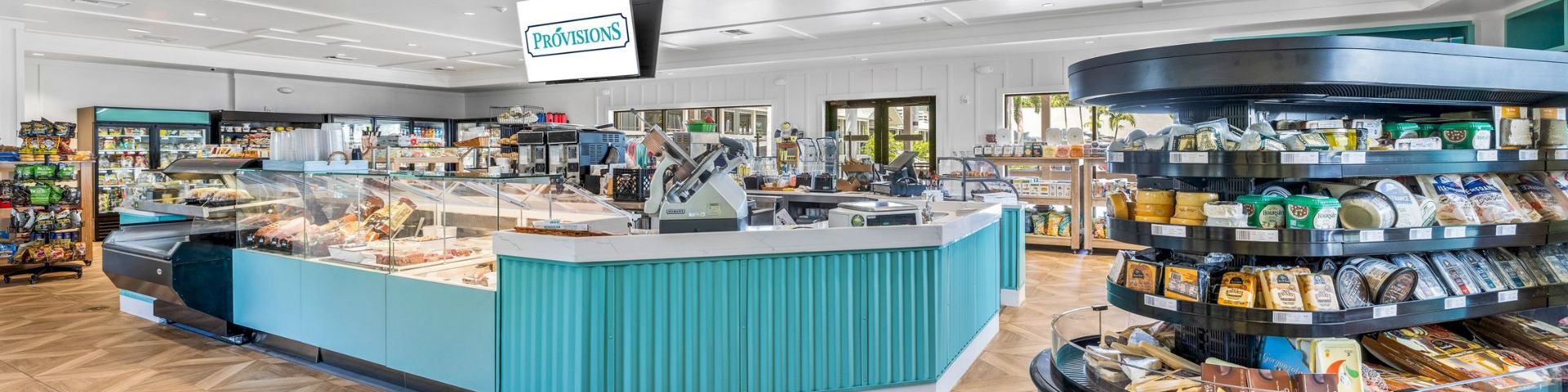 Inside view of a resort market with snacks and fresh food counters
