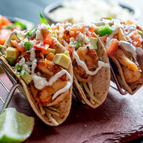 Grilled fish tacos with toppings and lime