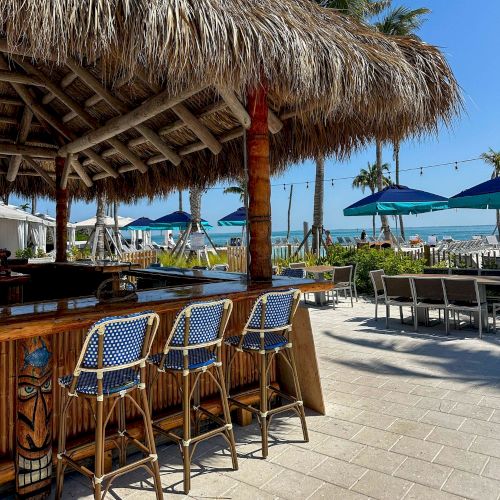 Trapon beach bar with blue chairs and ocean view