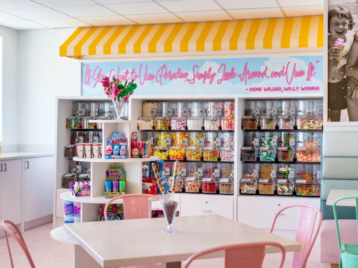 Colorful candy shop interior with jars and pink chairs