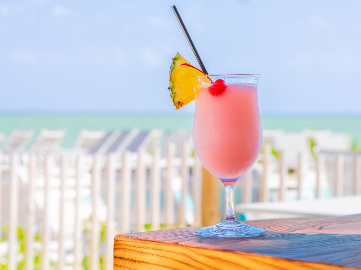 Frozen tropical cocktail with pineapple and cherry garnish