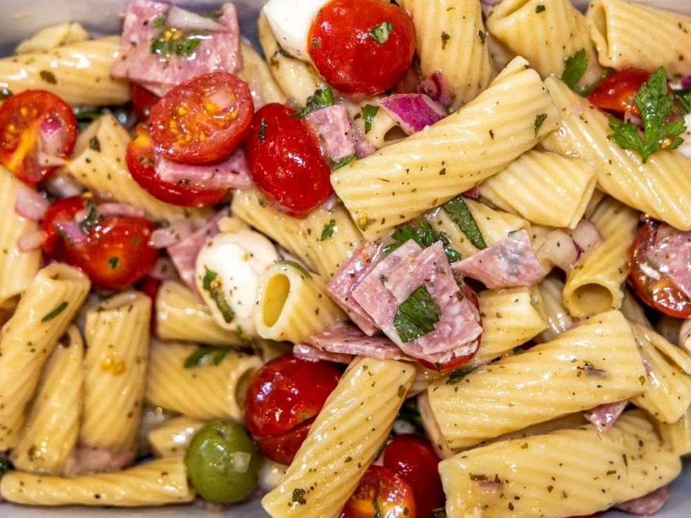 Italian pasta salad with tomatoes, mozzarella, and herbs