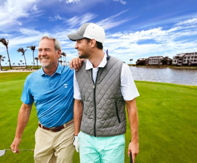 Two golfers smiling on the course