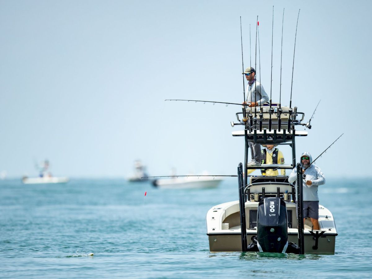 Fishermen on a boat with multiple fishing rods
