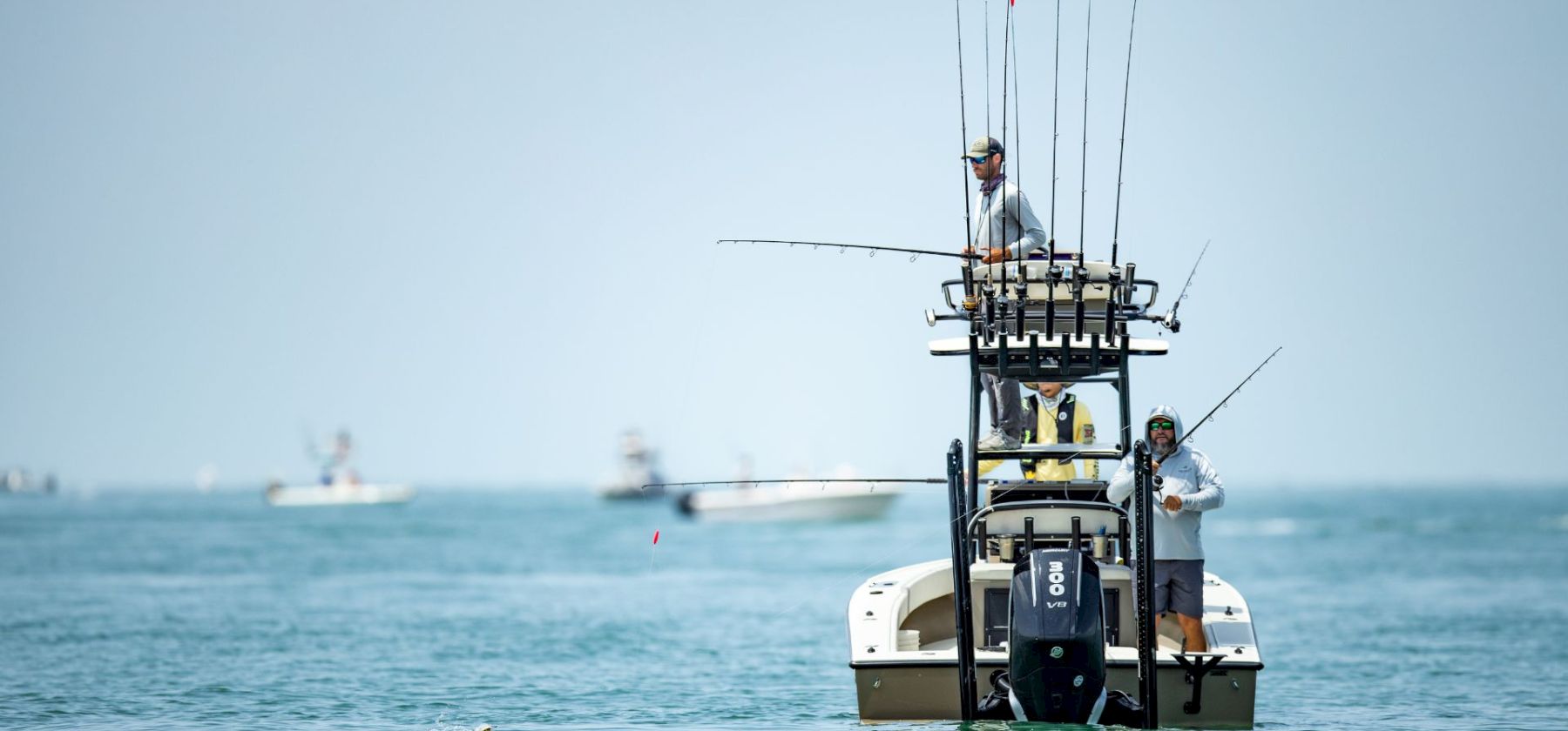 Fishermen on a boat with multiple fishing rods