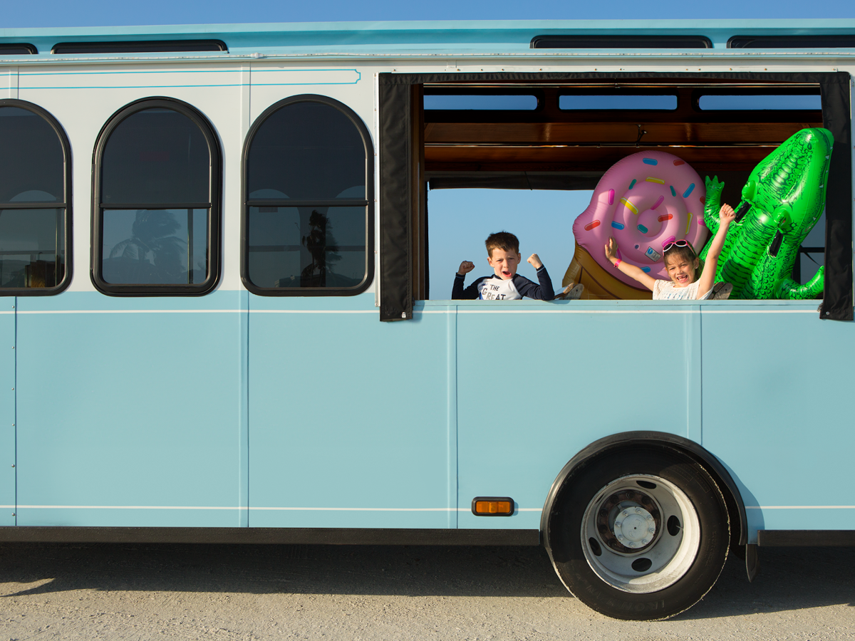 Children riding the resort trolley at South Seas