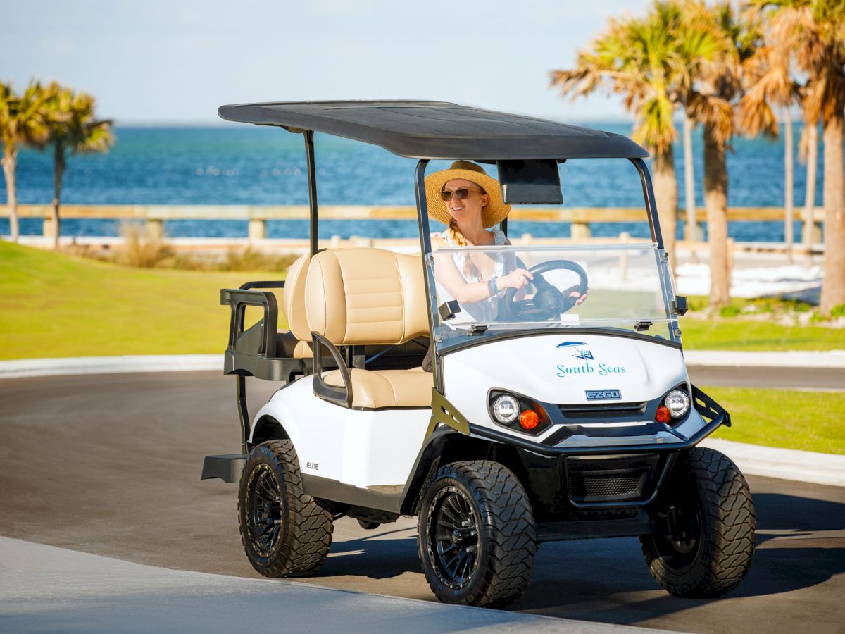 Guest driving a golf cart at South Seas