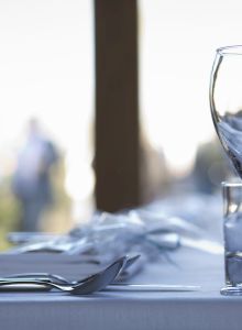 Close up of crockery and cutlery on a table.