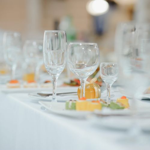 beautifully laid tables with glasses and appliances at morning in restaurant