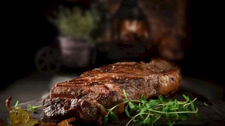 Juicy grilled steak served with fresh herbs