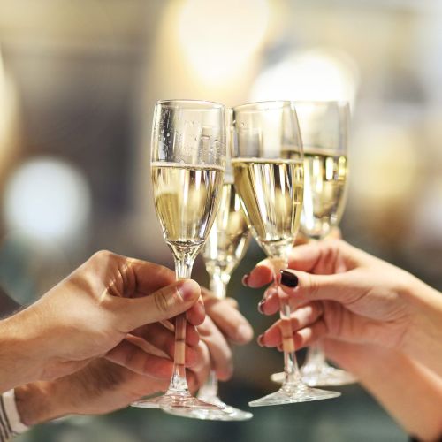 Celebration. People holding glasses of champagne making a toast. Champage with blurred background