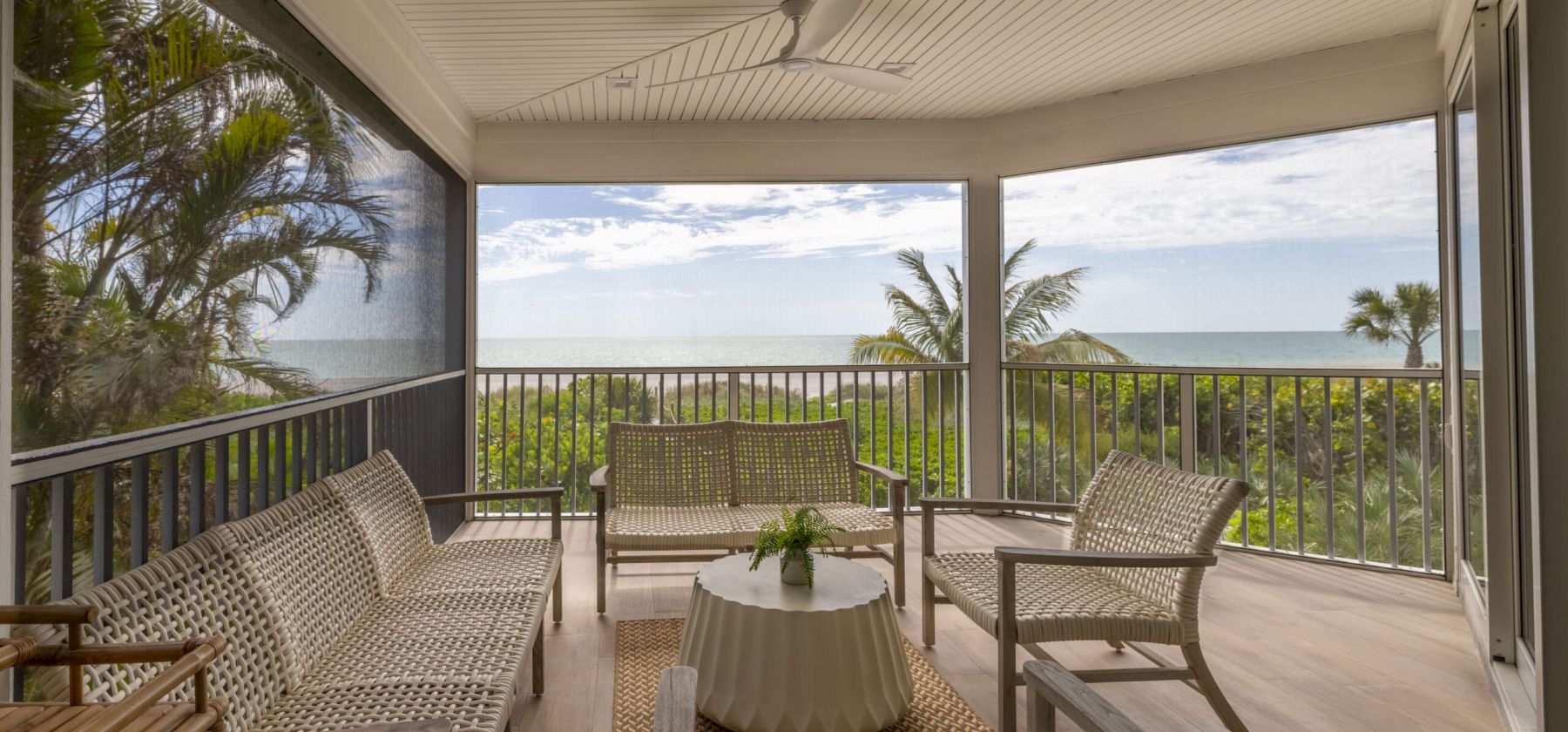 Outdoor patio with chairs and ocean view