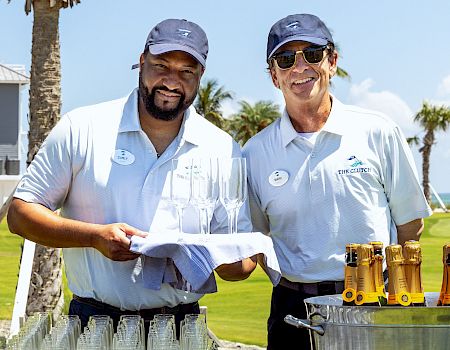 Two team members preparing to serve champaign on the golf course