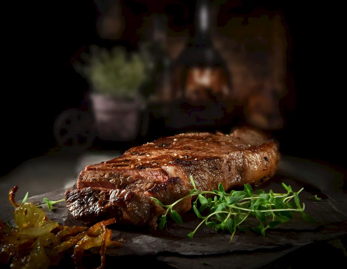 Juicy grilled steak served with fresh herbs