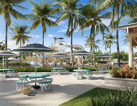 Shaded picnic area near the Captiva Landing water park play area, surrounded by palm trees