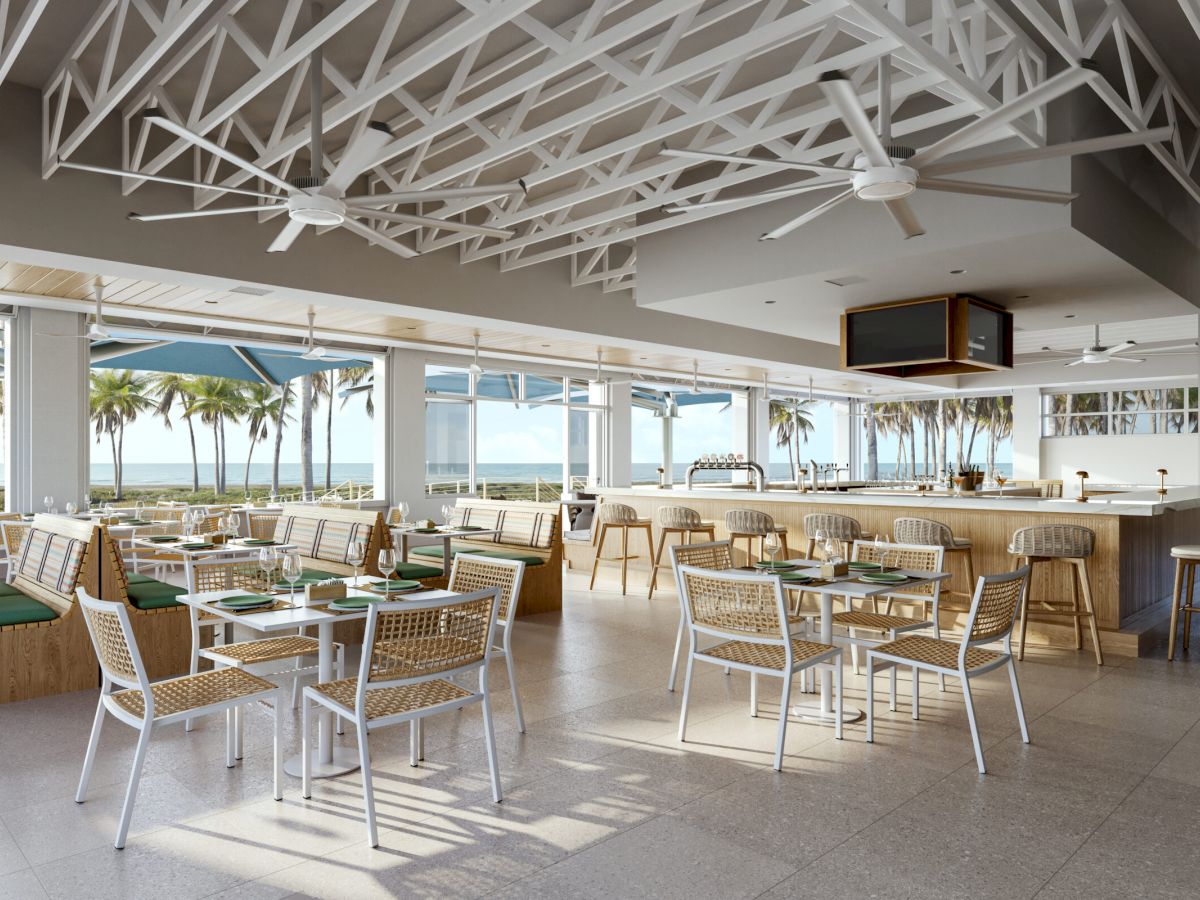 Bright restaurant interior with open air seating and sea view