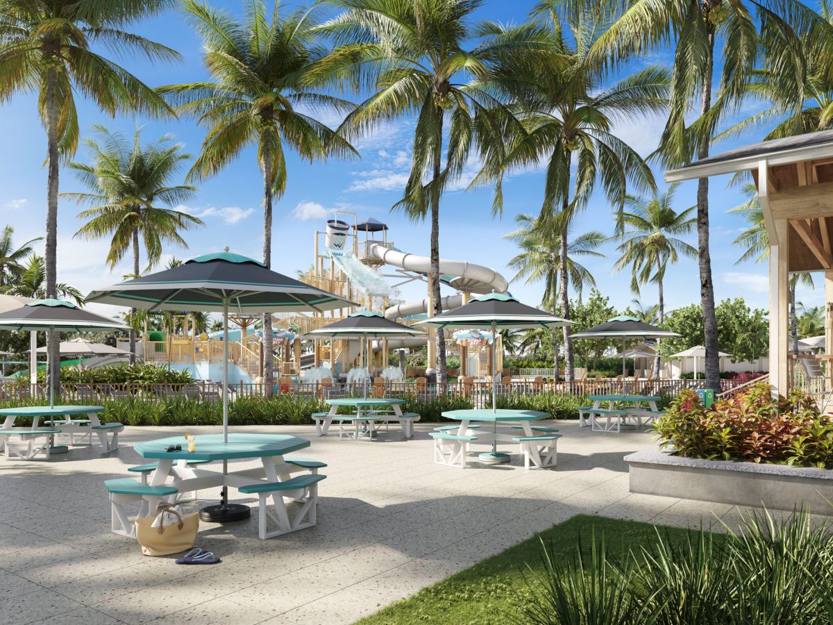 Shaded picnic area near the Captiva Landing water park play area, surrounded by palm trees
