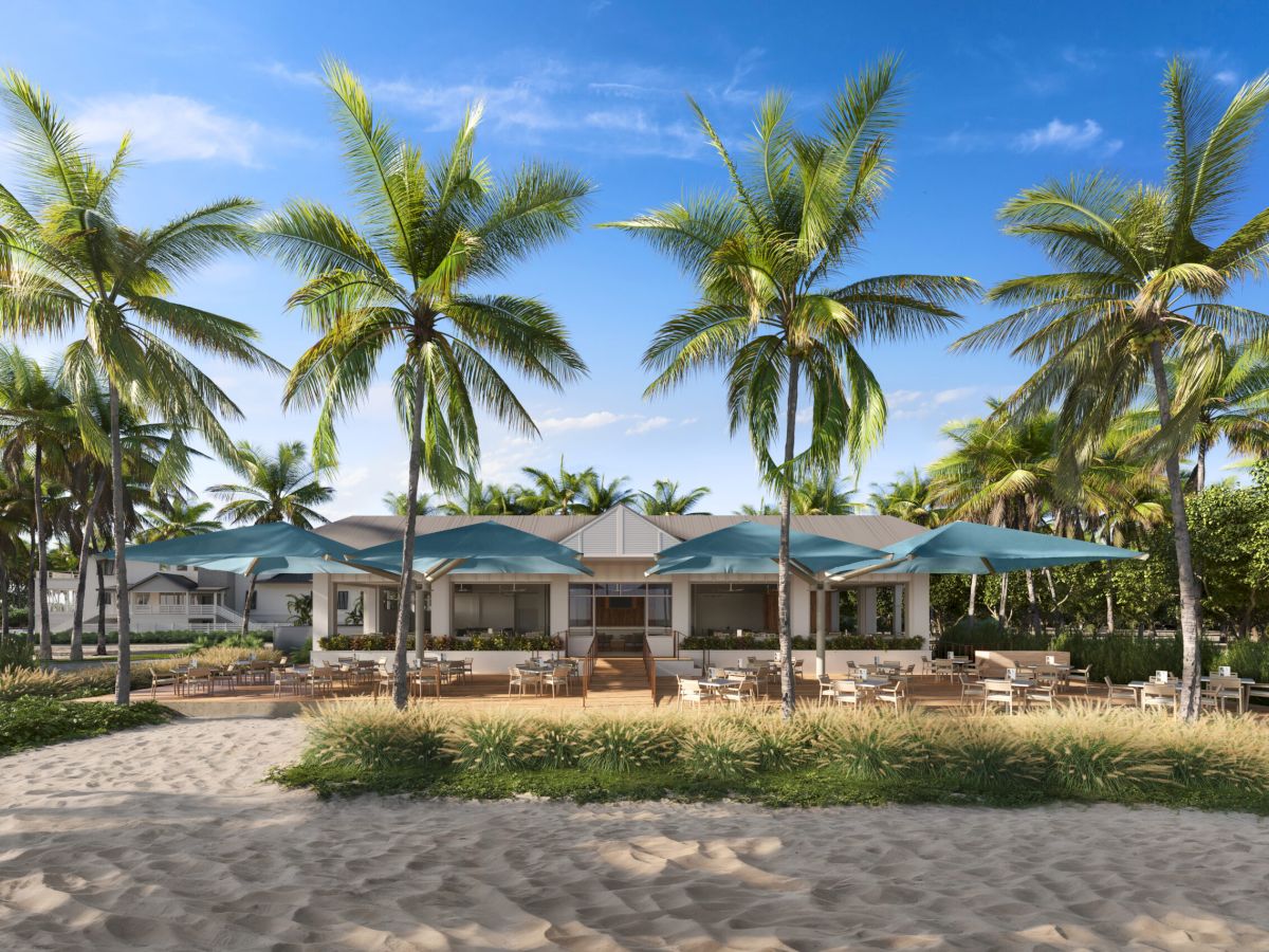 Beachside dining spot with palm trees and umbrellas