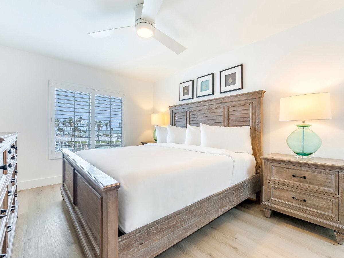Bright bedroom with wooden bed two lamps and window view