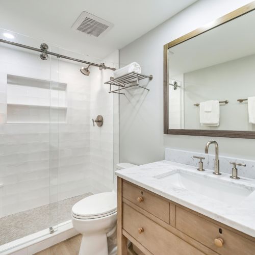 Bathroom with glass shower and wooden vanity