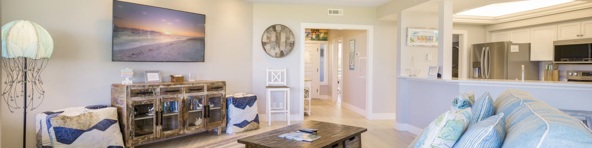 Cozy living room with blue sofa, wooden coffee table, and large ceiling fan