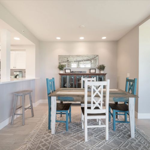 Dining area with white table and blue chairs