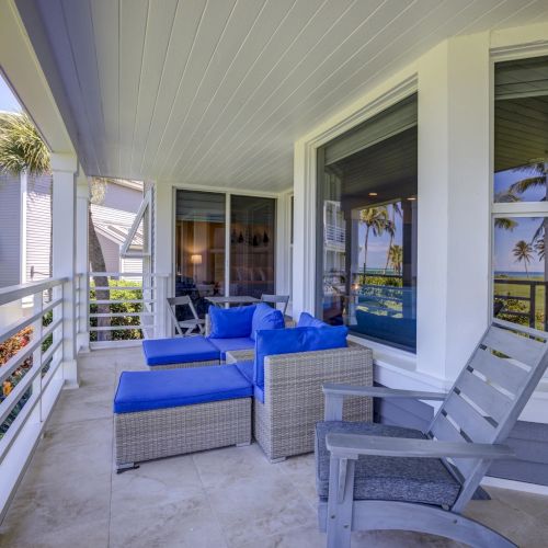 Covered patio with blue cushioned chairs and table