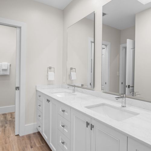 Double sink vanity in white bathroom