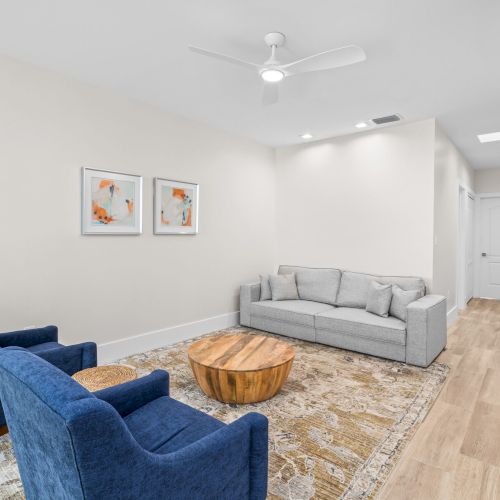 Small sitting area with gray and blue chairs