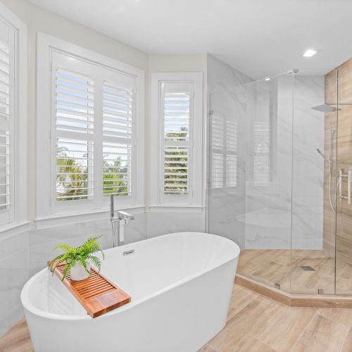 Bathroom with tub and glass shower