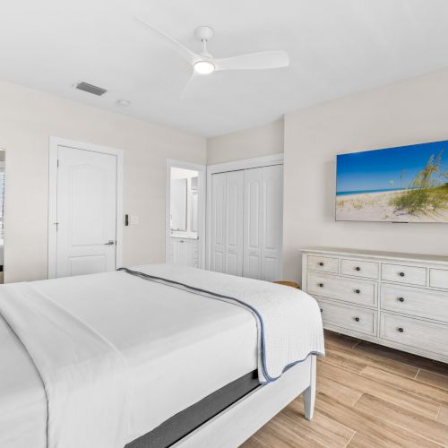 Minimal bedroom with white bed and dresser
