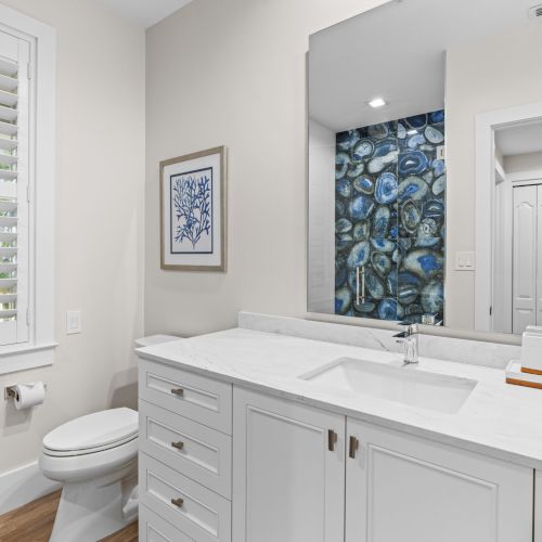Bathroom with single sink and blue art