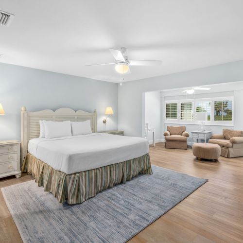 Bedroom with king bed, blue walls, and sitting area