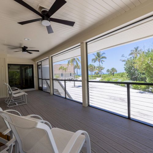 Screened porch with ceiling fans and patio chairs
