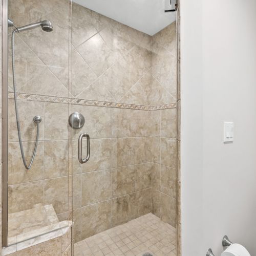 Bathroom with walk-in tile shower and bench