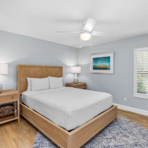 Bedroom with platform bed, nightstands, and blue rug