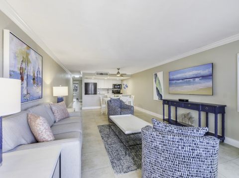 Living room with couches, chairs, and a dining area in the back.