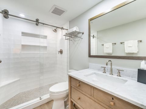 Bathroom with glass shower and wooden vanity