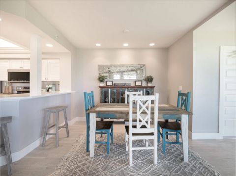Dining area with white table and blue chairs