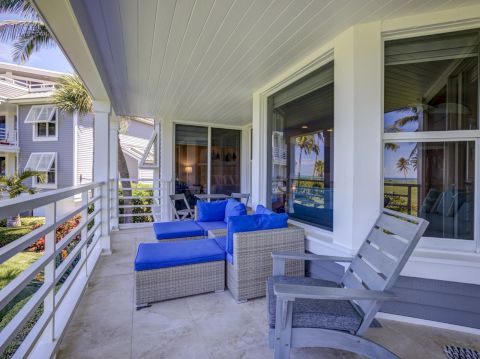 Covered patio with blue cushioned chairs and table