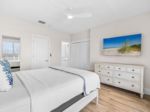 Minimal bedroom with white bed and dresser