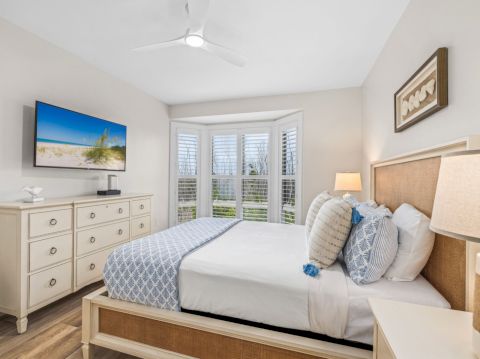 Bright bedroom with blue and white pillows